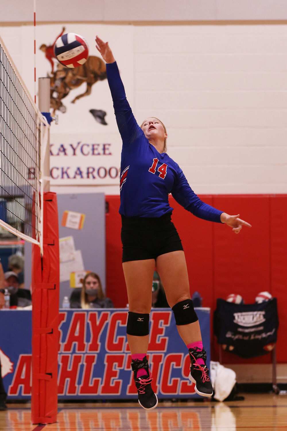 Braelyn Kozisek reaches to tip the ball back over the net